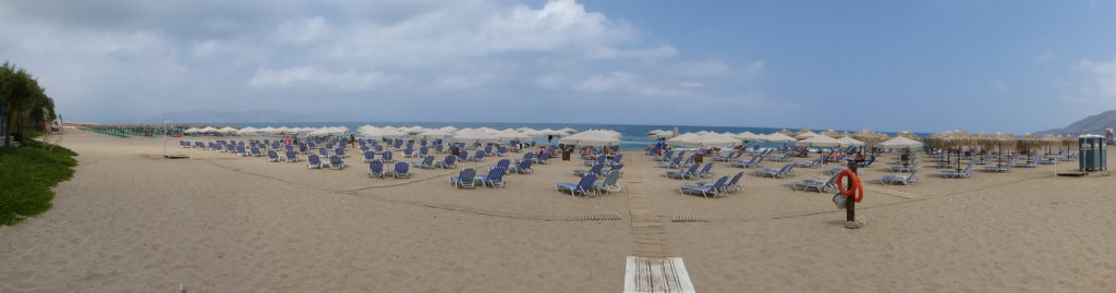 Ranked mass of sunbeds waiting for the crowds